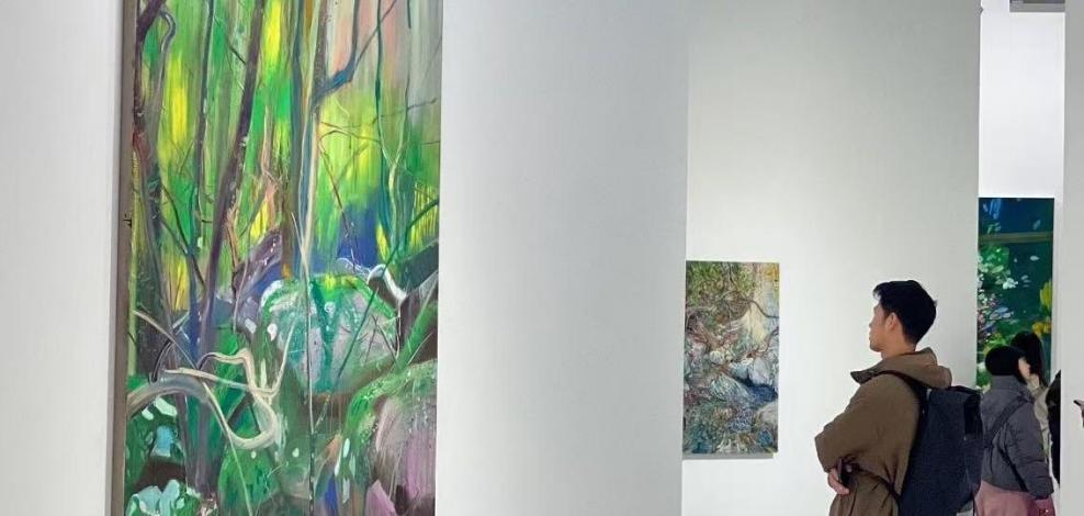 Visitors viewing contemporary paintings at Shanghai Powerlong Museum